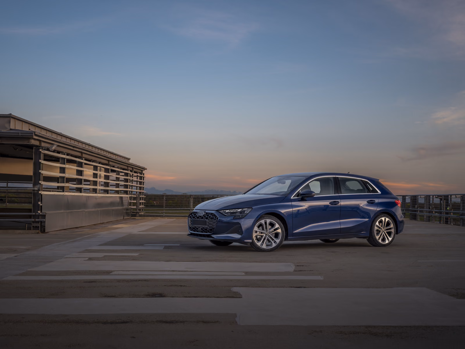 Audi A3 — синий кузов сзади в три четверти на закате