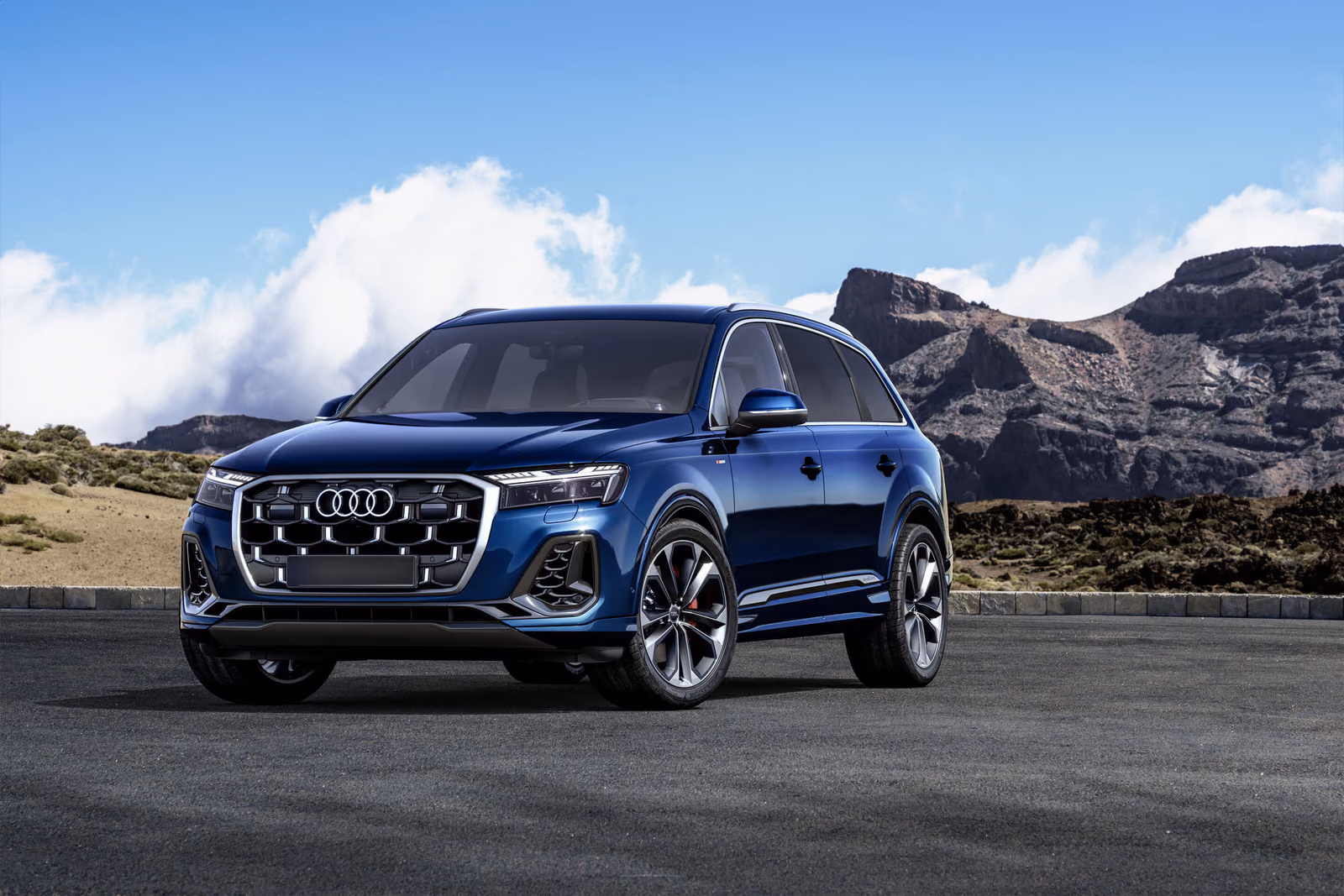 Audi Q7 — рестайлинг 2024, синий кузов спереди на фоне облаков