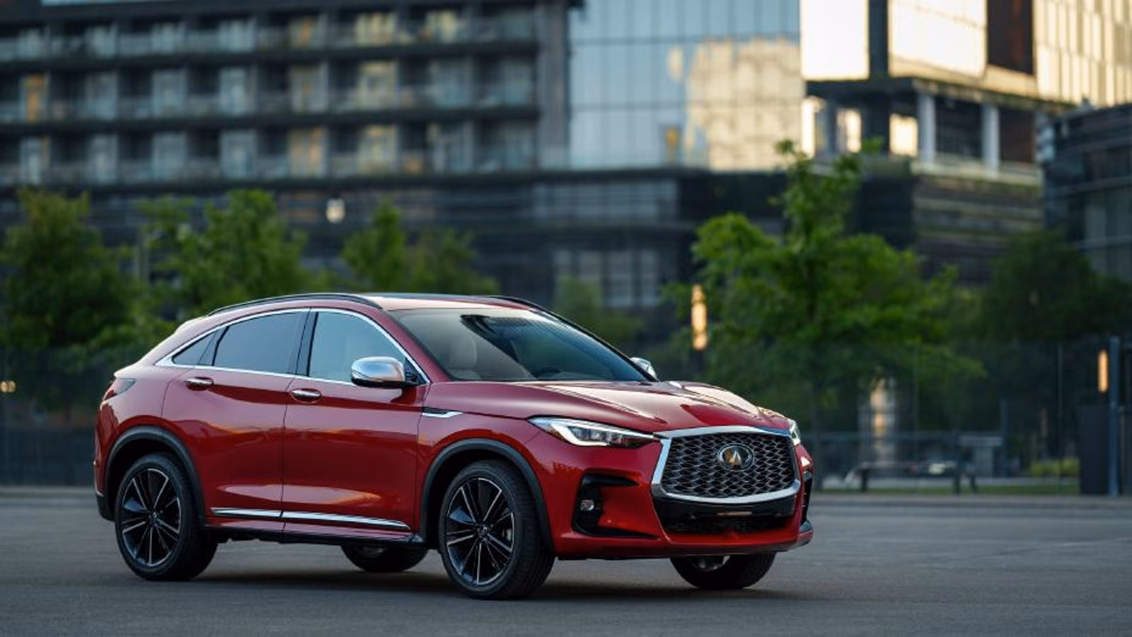 Красный Infiniti QX55 на городской площади