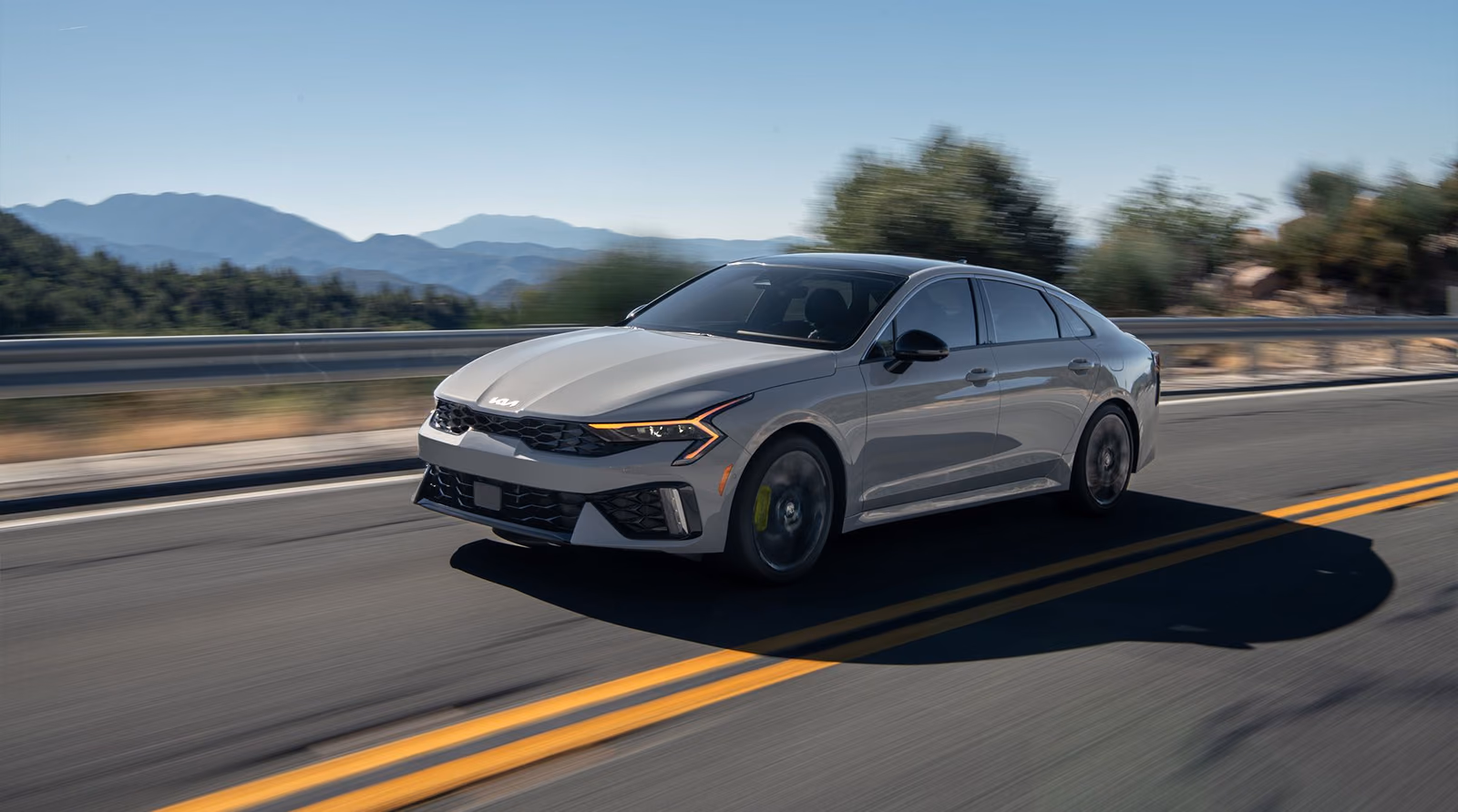 Kia K5 сзади в три четверти на трассе