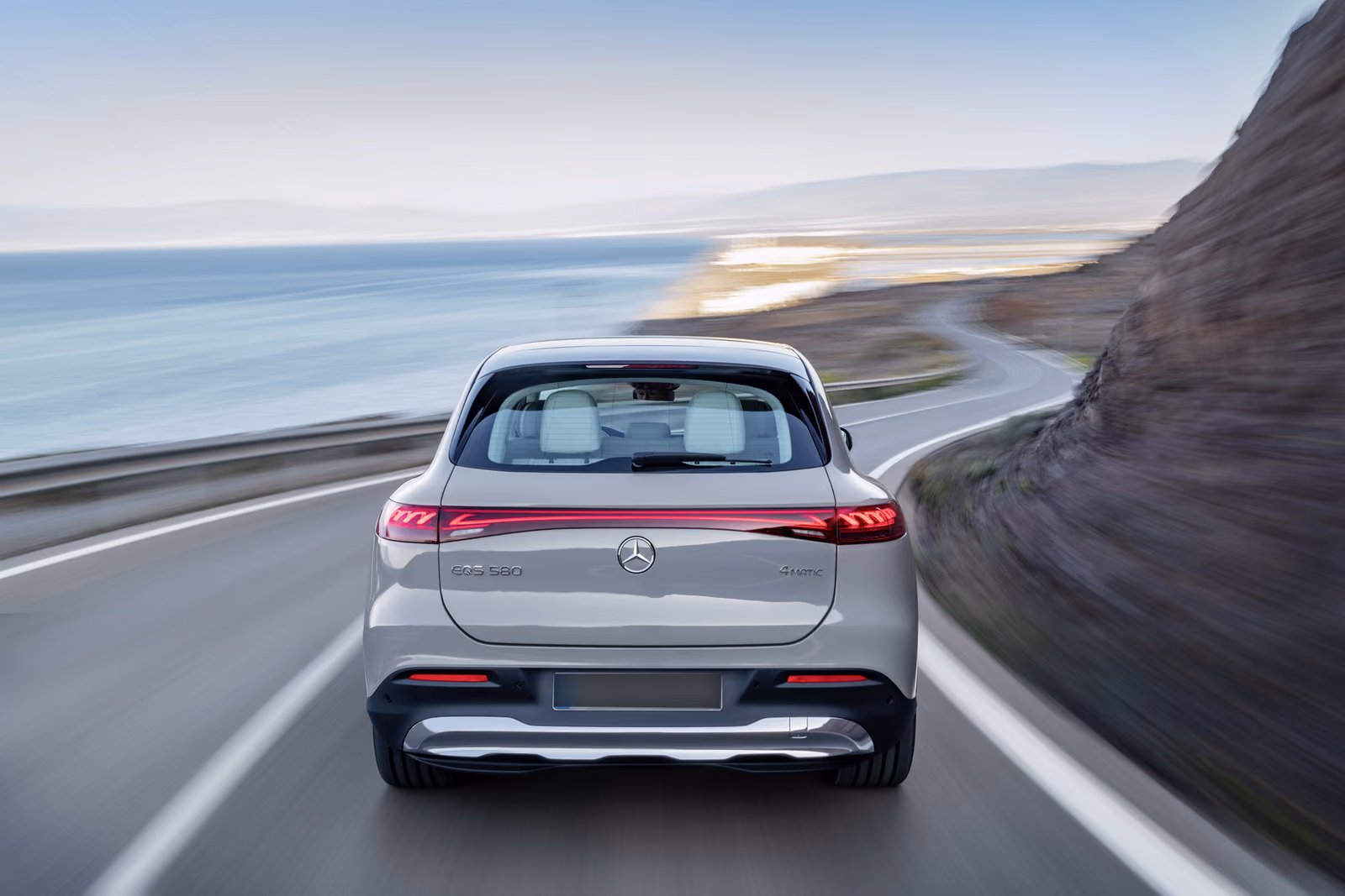 Mercedes-Benz EQS SUV — вид сзади на прибрежной трассе