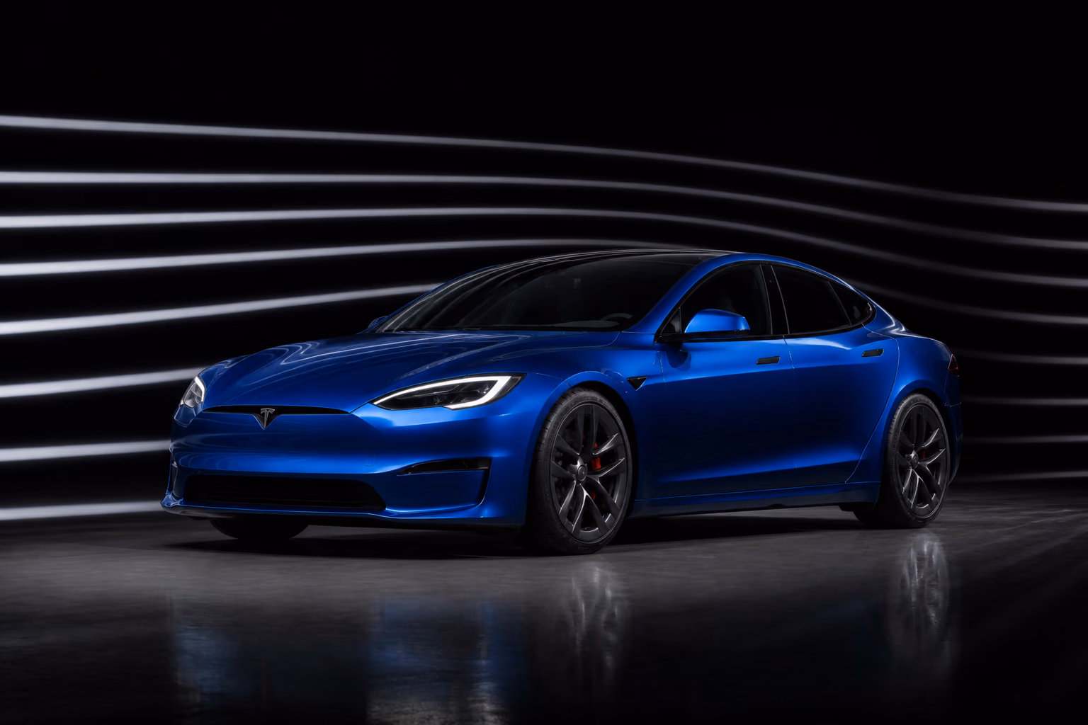 Синий Tesla Model S в тёмной аэродинамической студии