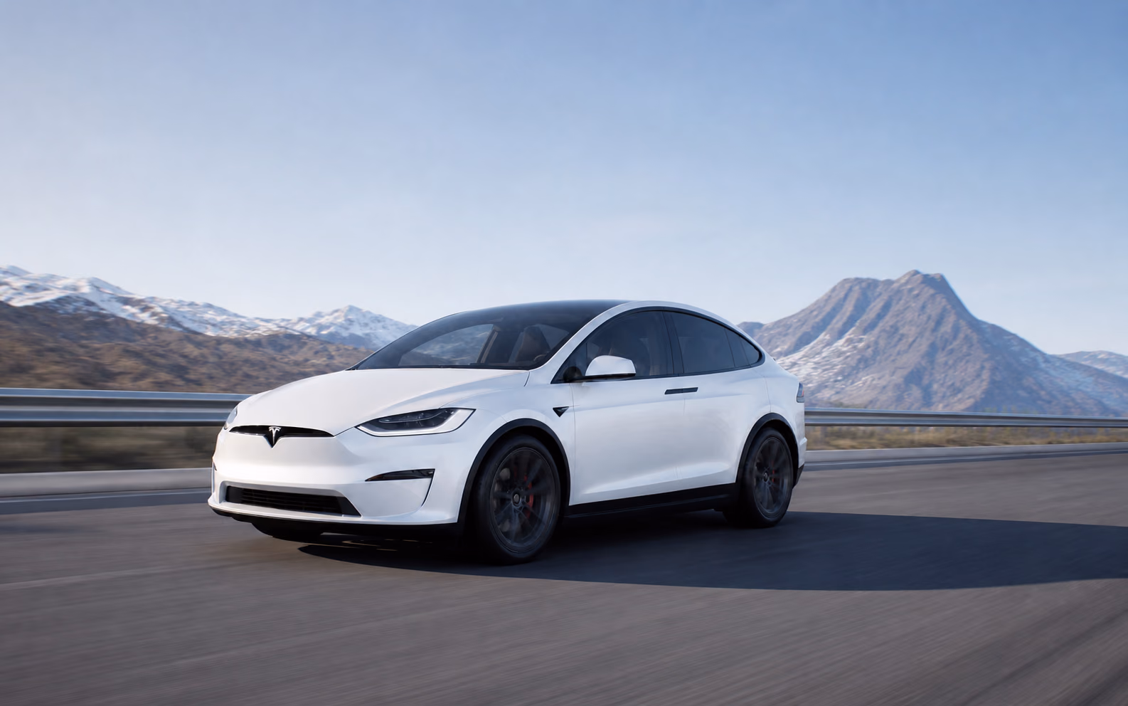 Белая Tesla Model X на горной трассе