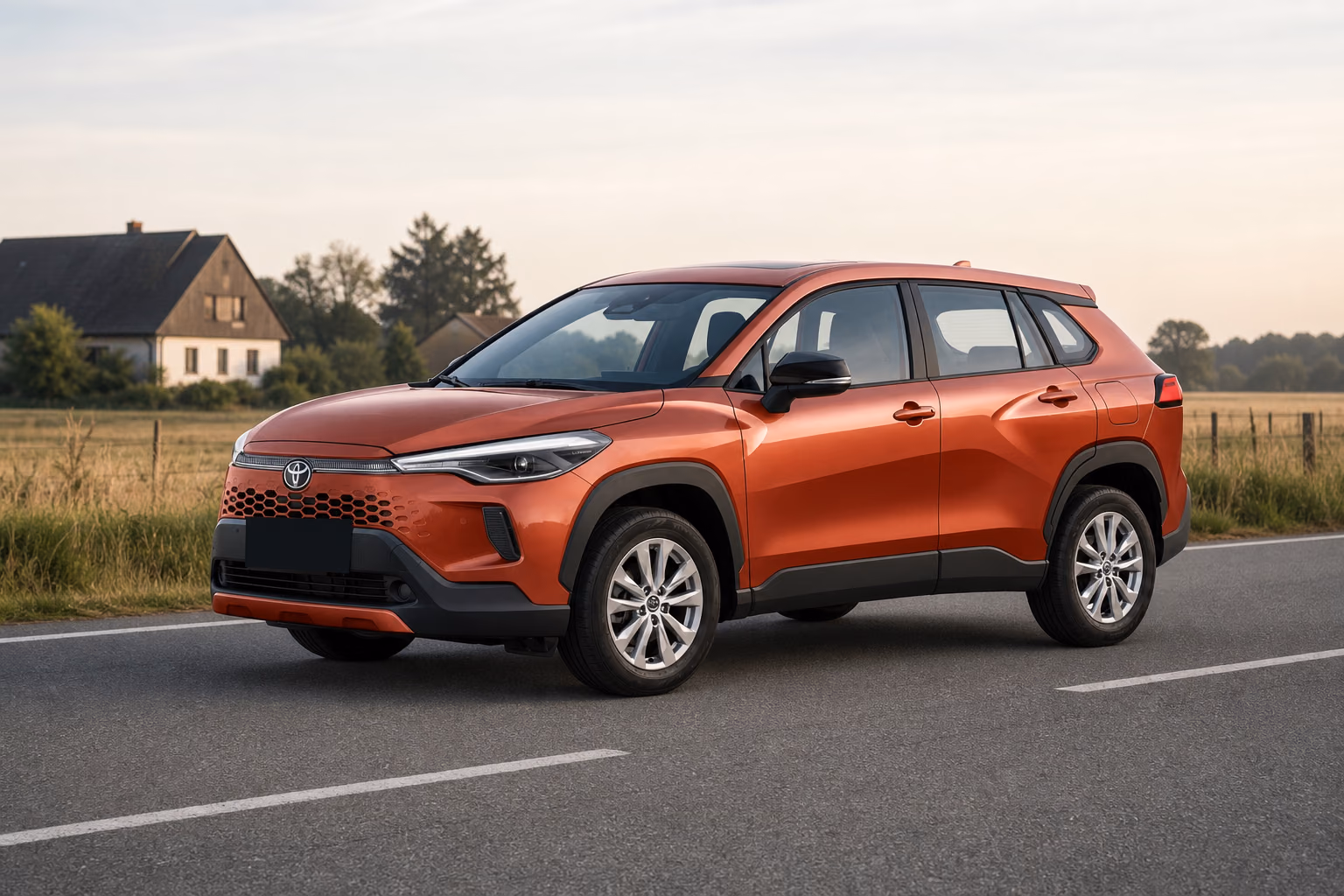 Медная Toyota Corolla Cross на загородной дороге рядом с домами